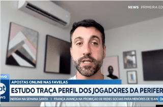 Man with dark hair and white shirt giving news interview in home